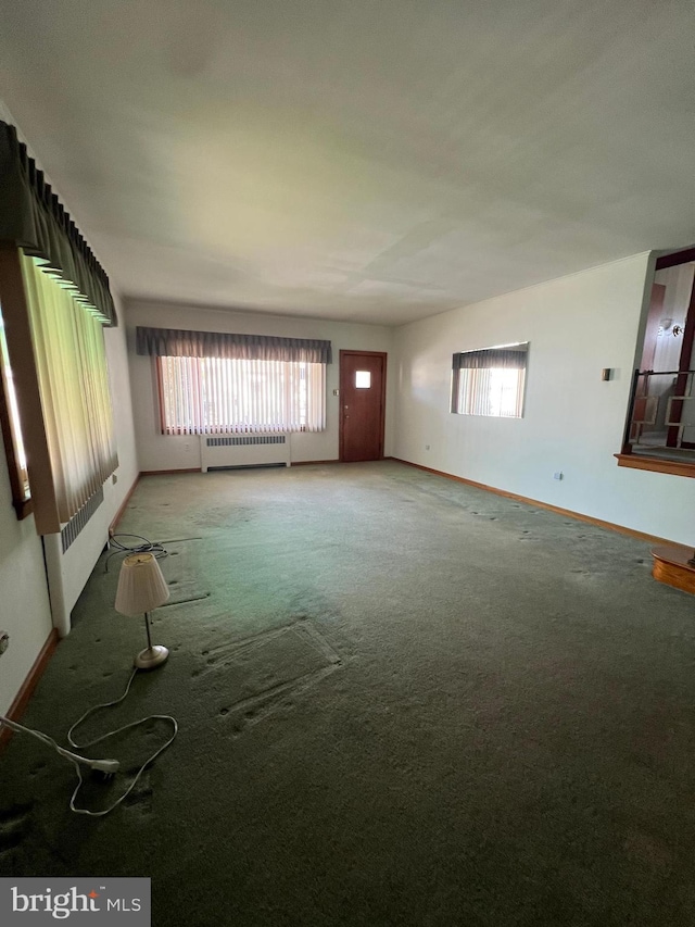 1228 Spruce St, Ashland, PA 17921 - empty room featuring baseboards, light carpet, and a healthy amount of sunlight