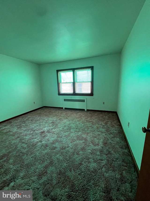 1228 Spruce St, Ashland, PA 17921 - spare room featuring radiator, carpet, and baseboards