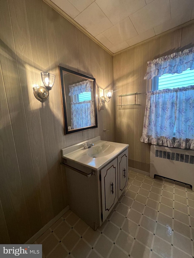 1228 Spruce St, Ashland, PA 17921 - bathroom with radiator, wooden walls, and vanity