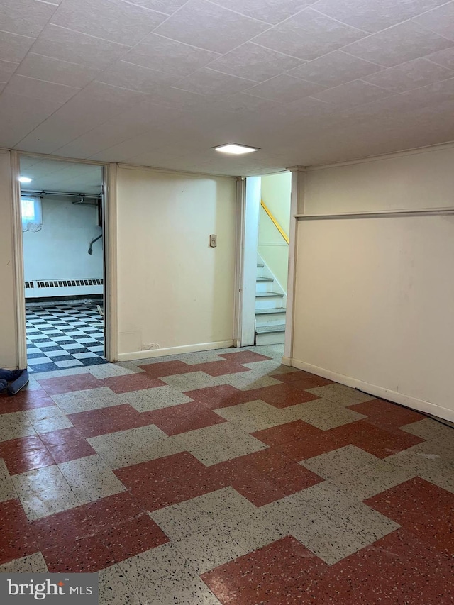 1228 Spruce St, Ashland, PA 17921 - finished basement with baseboards, stairs, and a baseboard radiator