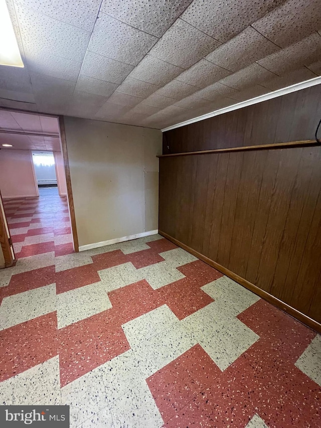 1228 Spruce St, Ashland, PA 17921 - spare room with tile patterned floors, wood walls, baseboards, and a drop ceiling