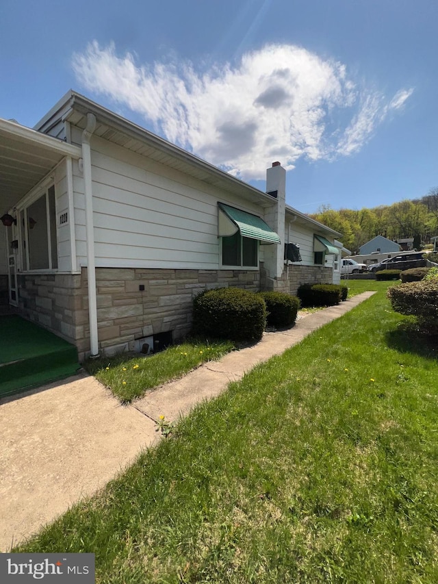 1228 Spruce St, Ashland, PA 17921 - view of side of home with stone siding, a chimney, and a lawn