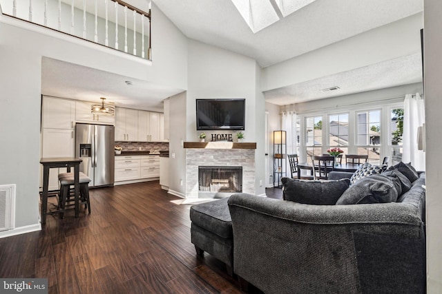 3901 Golf Tee Ct Unit 301, Fairfax, VA 22033 - living room with a fireplace with flush hearth, dark wood-type flooring, a skylight, and baseboards