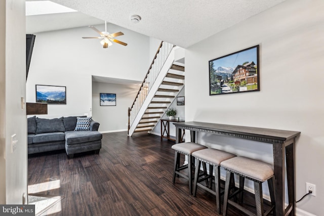 3901 Golf Tee Ct Unit 301, Fairfax, VA 22033 - living room featuring stairs, dark wood-style floors, ceiling fan, baseboards, and high vaulted ceiling