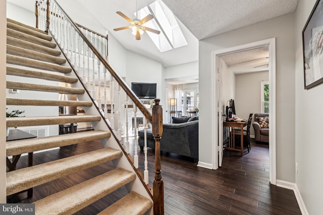 3901 Golf Tee Ct Unit 301, Fairfax, VA 22033 - staircase with ceiling fan, baseboards, wood finished floors, a skylight, and vaulted ceiling