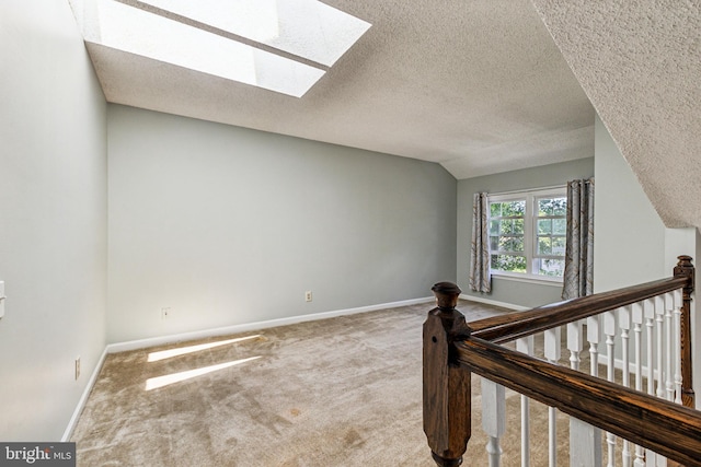3901 Golf Tee Ct Unit 301, Fairfax, VA 22033 - additional living space featuring a skylight, carpet, a textured ceiling, baseboards, and vaulted ceiling