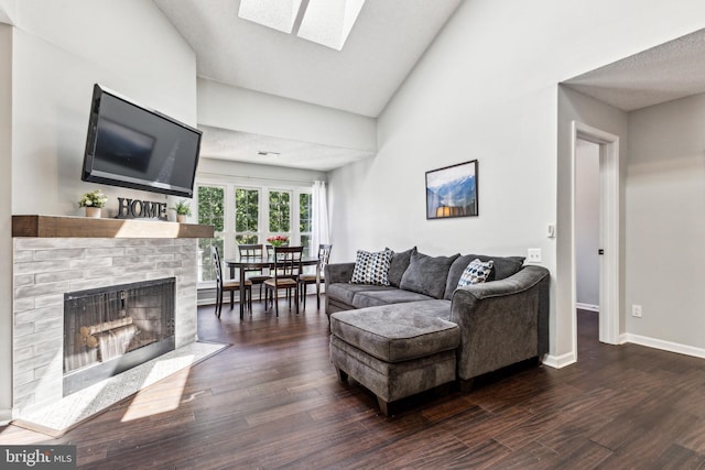3901 Golf Tee Ct Unit 301, Fairfax, VA 22033 - living room with dark wood-type flooring, a brick fireplace, a skylight, baseboards, and lofted ceiling