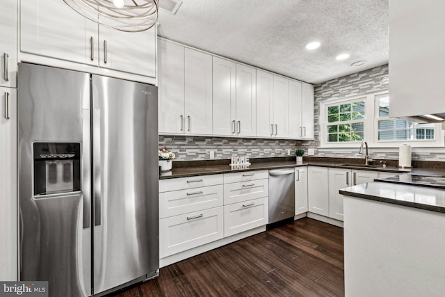 3901 Golf Tee Ct Unit 301, Fairfax, VA 22033 - kitchen featuring stainless steel appliances, a textured ceiling, a sink, dark wood finished floors, and white cabinetry