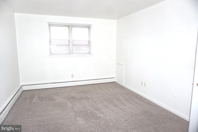 empty room featuring carpet, a baseboard radiator, and baseboards