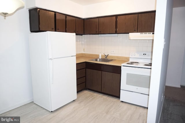 kitchen with white appliances, a sink, under cabinet range hood, light countertops, and dark brown cabinets