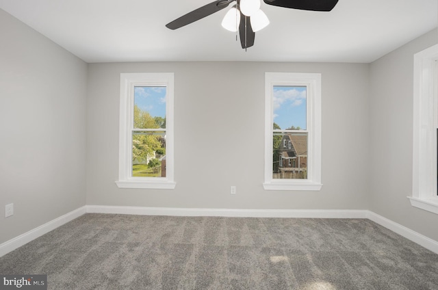 unfurnished room featuring carpet flooring, baseboards, and a ceiling fan