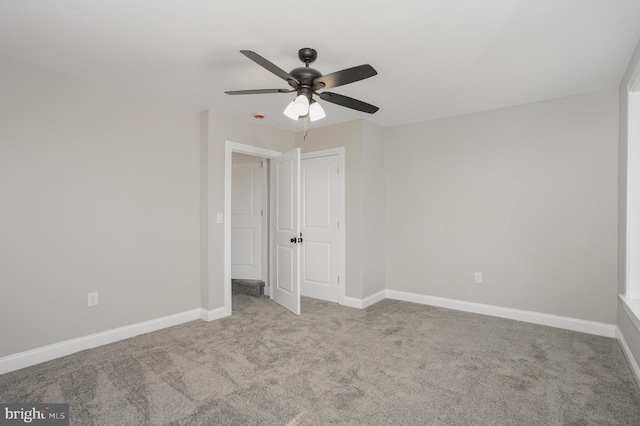 unfurnished bedroom with baseboards, ceiling fan, and carpet