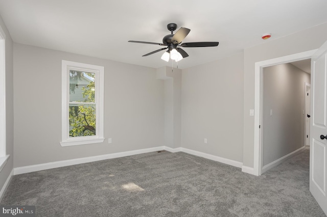 empty room with baseboards, ceiling fan, and carpet floors