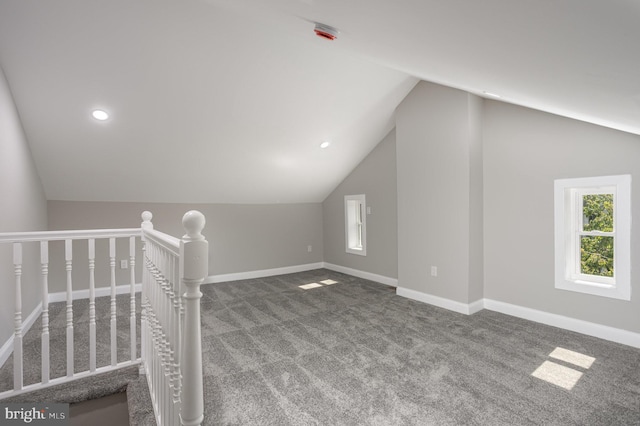 additional living space with lofted ceiling, carpet floors, and baseboards
