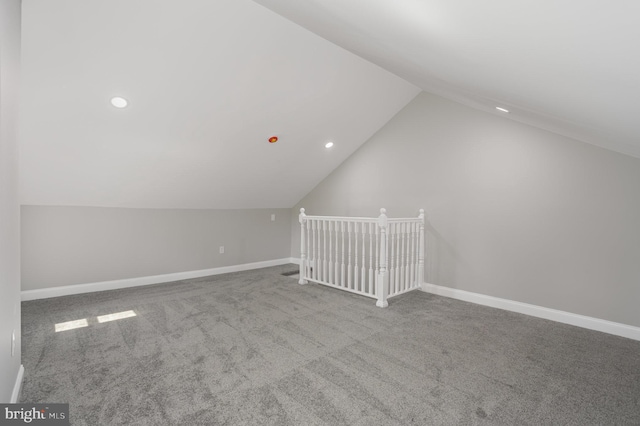 additional living space featuring vaulted ceiling, carpet, baseboards, and recessed lighting