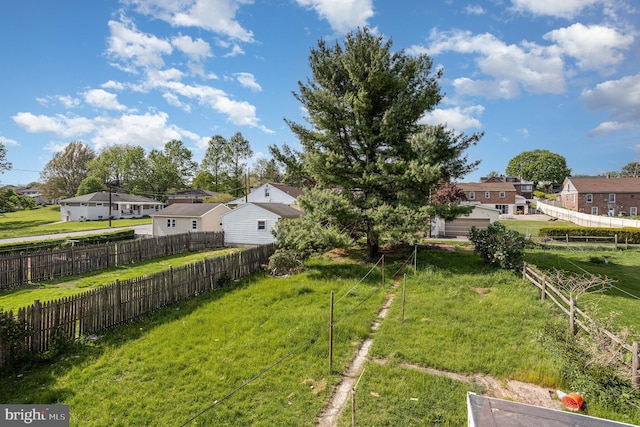 view of yard with fence and a residential view