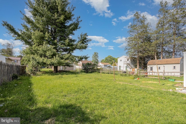 view of yard with a residential view and fence