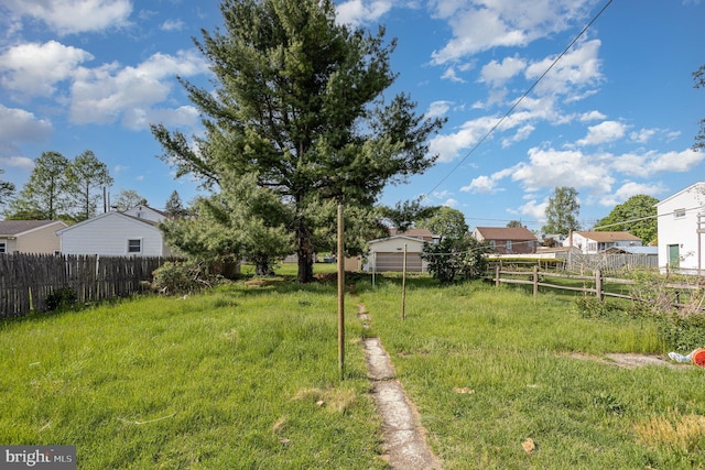 view of yard featuring a residential view and fence