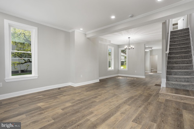 unfurnished living room with stairway, an inviting chandelier, baseboards, and dark wood-type flooring
