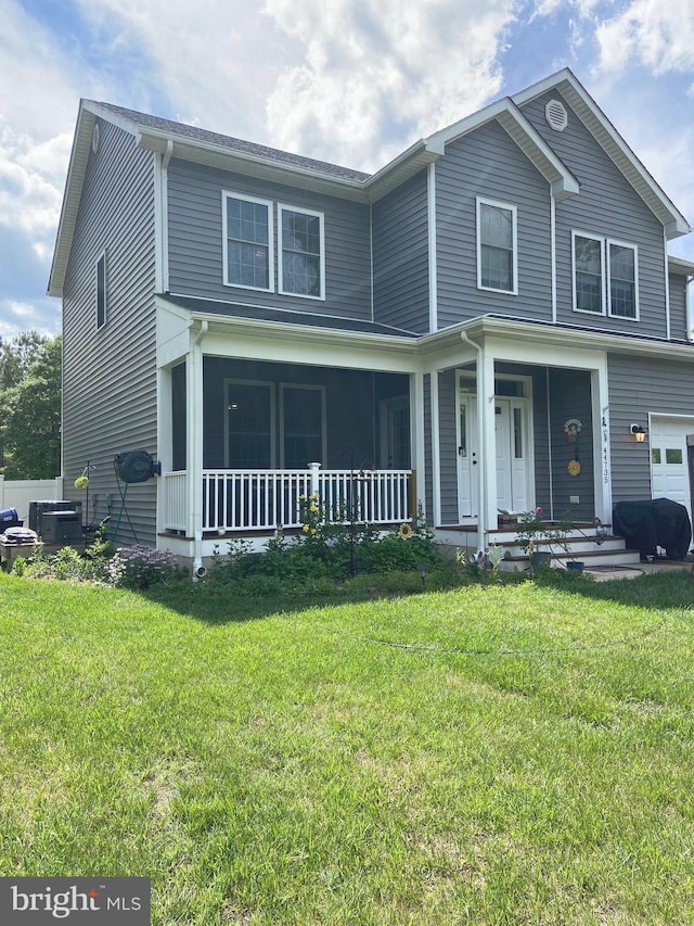 traditional home with a front lawn and central AC