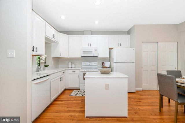 6343 Wind Rider Way, Columbia, MD 21045 - kitchen with white appliances, a center island, white cabinets, light countertops, and recessed lighting