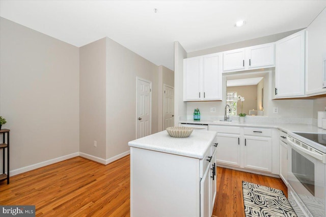 6343 Wind Rider Way, Columbia, MD 21045 - kitchen with white appliances, a center island, light wood finished floors, and white cabinets