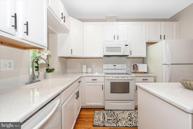 6343 Wind Rider Way, Columbia, MD 21045 - kitchen featuring white appliances, white cabinets, light wood-type flooring, and light stone countertops
