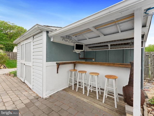 exterior space featuring fence and outdoor dry bar