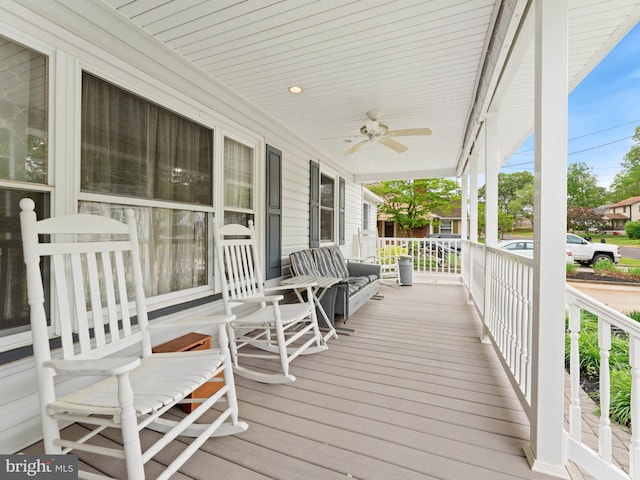 wooden deck featuring a porch and a ceiling fan