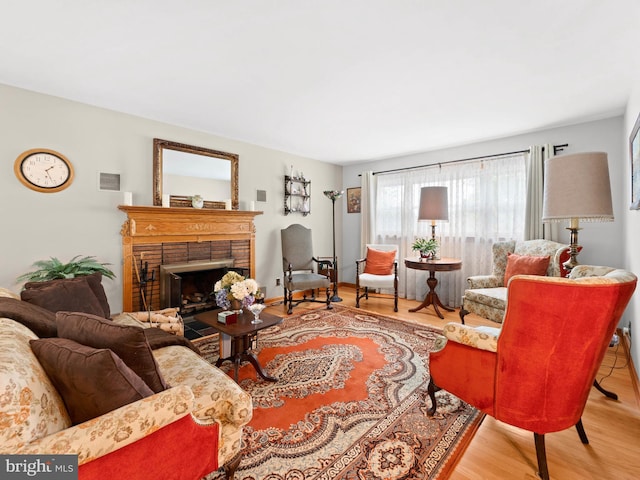 living room featuring visible vents, wood finished floors, and a fireplace