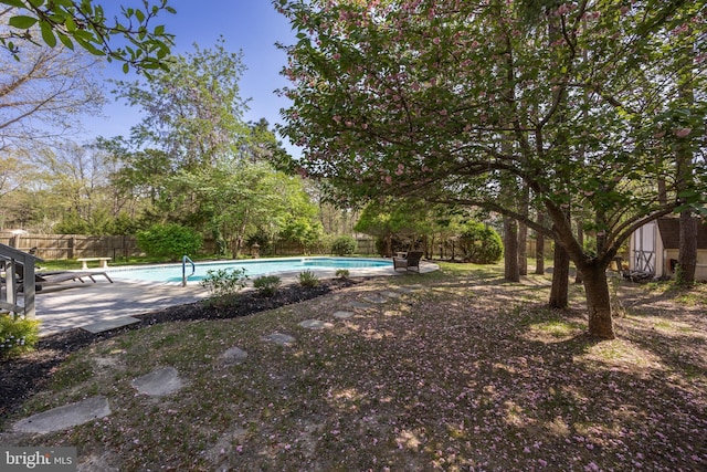 view of yard featuring a patio, a fenced in pool, and a fenced backyard