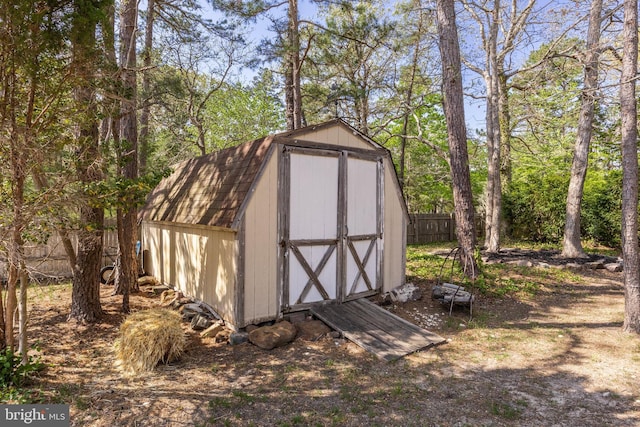 view of shed featuring fence