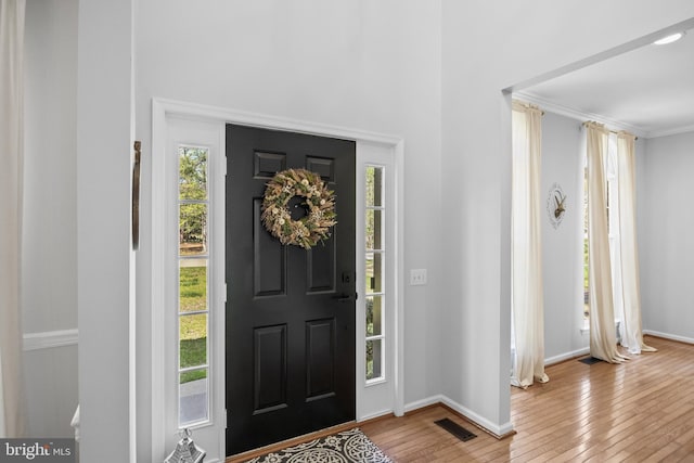 entrance foyer featuring baseboards, light wood-type flooring, and visible vents