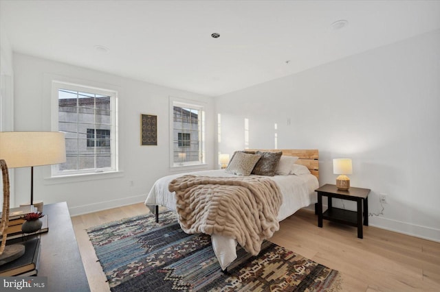 128 E Sharpnack St, Philadelphia, PA 19119 - bedroom with light wood finished floors, multiple windows, and baseboards