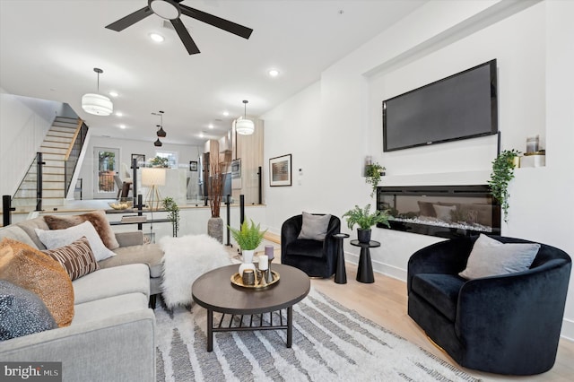 128 E Sharpnack St, Philadelphia, PA 19119 - living room featuring stairs, a ceiling fan, wood finished floors, a glass covered fireplace, and recessed lighting