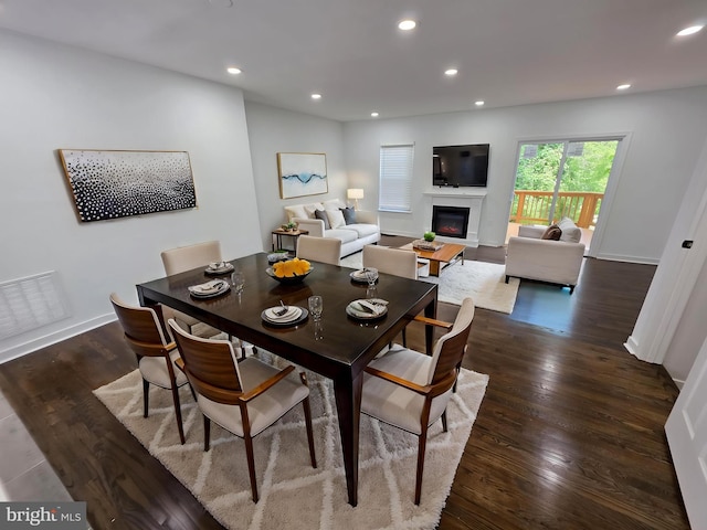 23 Grotto Ct, Germantown, MD 20874 - dining space featuring a glass covered fireplace, dark wood-type flooring, recessed lighting, and baseboards