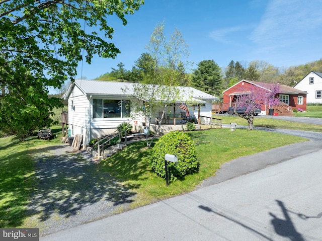single story home featuring a front lawn and metal roof