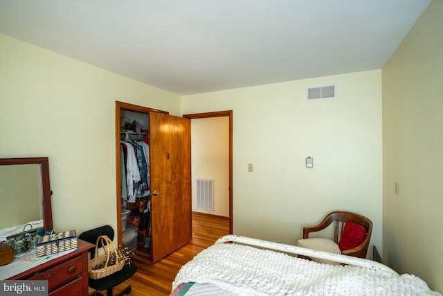 bedroom featuring wood finished floors and a closet
