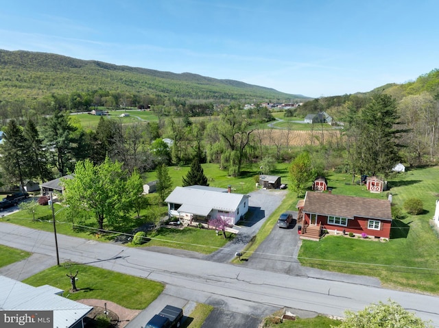 drone / aerial view featuring a forest view and a mountain view