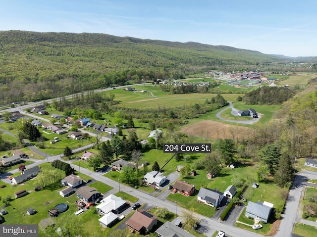 drone / aerial view with a forest view and a residential view