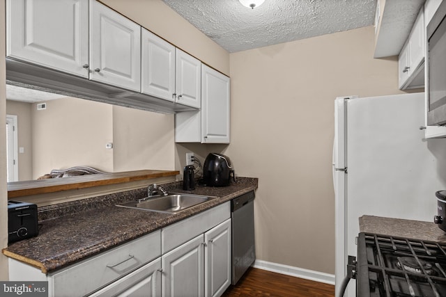 kitchen with a sink, dishwasher, white cabinets, dark countertops, and baseboards
