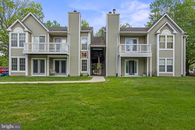 back of property featuring french doors, a lawn, and a chimney