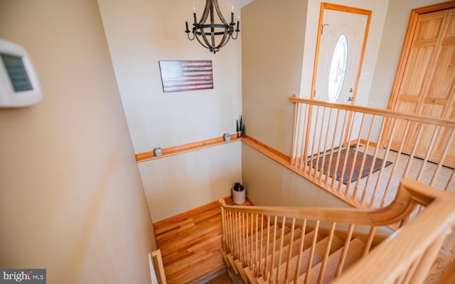 97 Heverly Ln, Beech Creek, PA 16822 - staircase with wood finished floors, baseboards, and a notable chandelier