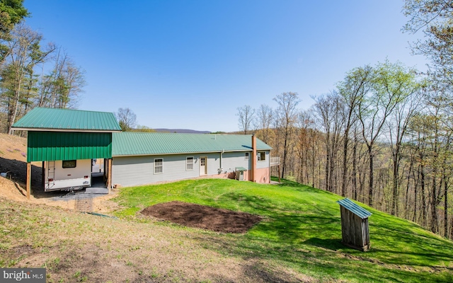 97 Heverly Ln, Beech Creek, PA 16822 - rear view of house with a yard, metal roof, and a carport