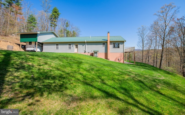 97 Heverly Ln, Beech Creek, PA 16822 - rear view of property featuring metal roof, a yard, and a chimney