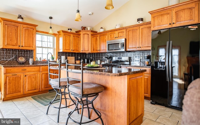97 Heverly Ln, Beech Creek, PA 16822 - kitchen featuring light tile patterned floors, a kitchen bar, stainless steel appliances, a kitchen island, and tasteful backsplash