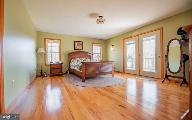 97 Heverly Ln, Beech Creek, PA 16822 - bedroom with multiple windows, baseboards, access to exterior, and hardwood / wood-style floors