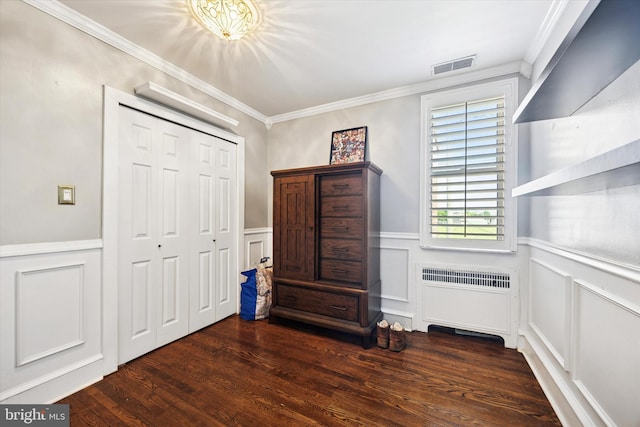 2935 S 13th St, Philadelphia, PA 19148 - bedroom featuring a decorative wall, ornamental molding, radiator heating unit, wood finished floors, and a closet
