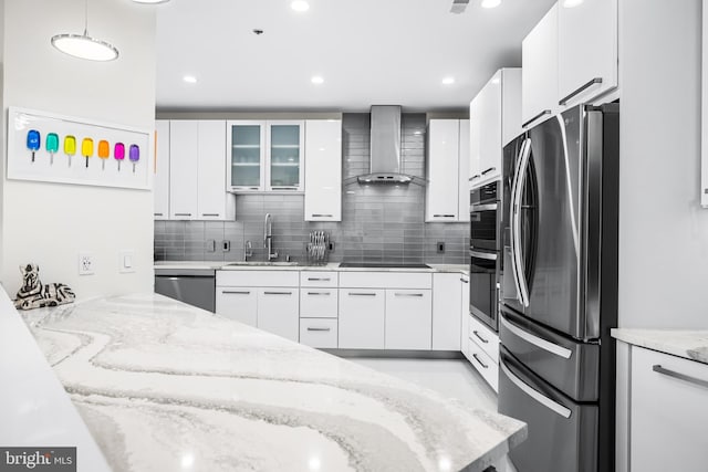 100 Harborview Dr Unit 2107, Baltimore, MD 21230 - kitchen featuring stainless steel appliances, wall chimney range hood, a sink, tasteful backsplash, and light stone counters