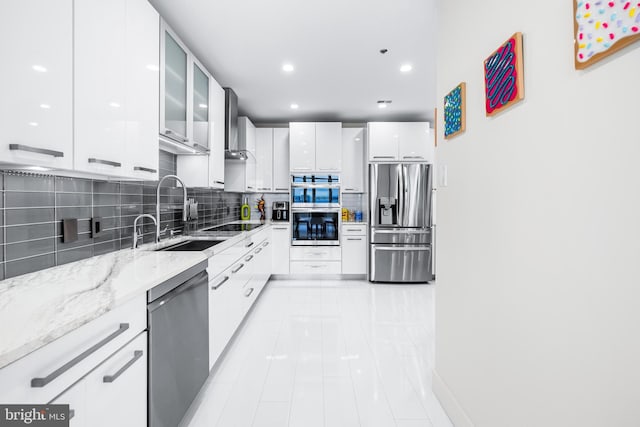100 Harborview Dr Unit 2107, Baltimore, MD 21230 - kitchen featuring appliances with stainless steel finishes, a sink, modern cabinets, decorative backsplash, and white cabinetry